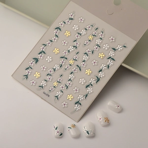Detailed 5D embossed nail stickers featuring white petals and golden floral vine motifs
