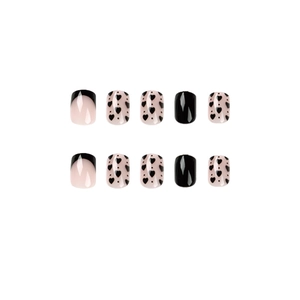 French press-on nails set featuring black tips, heart designs and solid black finish