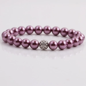 Detailed shot of dark purple pearl bracelet with a silver hollow rhinestone charm ball