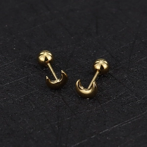 Macro shot of 16G gold crescent moon studs with ball screw backs in polished finish
