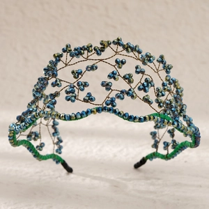 Detail of handcrafted blue and green crystal beads on a woven wire bridal headband