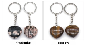 Detail view of heart-shaped Rhodonite and Tiger Eye natural stone keychains with metal rings