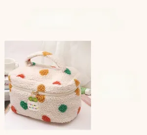 Detail of soft fleece makeup bag with colorful polka dots and sunflower zipper charm