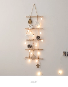 Detail of wooden branch Christmas tree wall hanging with LED lights and XMAS ornaments