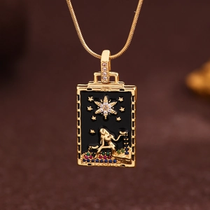 Macro shot of gold tarot pendant with black enamel, star pattern and zircon inlay