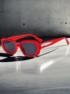 Detailed close-up of red square frame sunglasses with sleek metal trim on the temples