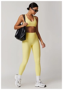 Close-up of bright yellow yoga set featuring high-waist leggings and V-neck sports bra