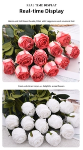 Detail view of pink and white artificial roses with realistic petals and green leaves