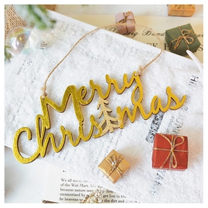 Macro detail of golden glitter Merry Christmas wooden ornament with reindeer tree design