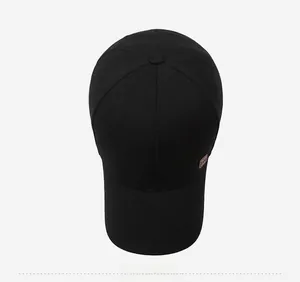 Top view of black cotton baseball cap showing six-panel crown and brown leather side patch