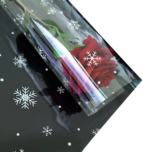 Black semi-transparent flower wrapping paper with snowflakes and a red rose