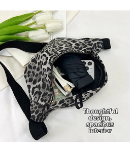 Detailed view of leopard print crossbody bag showing storage for phone and umbrella