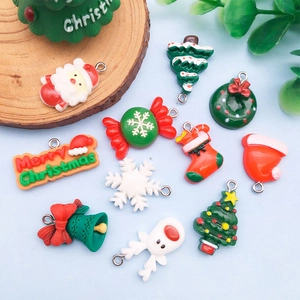 Detailed view of colorful Christmas resin charms like Santa, trees and bells for DIY bracelets
