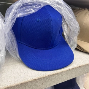 Detail of navy blue flat brim hip hop cap with reinforced stitching and ventilation holes