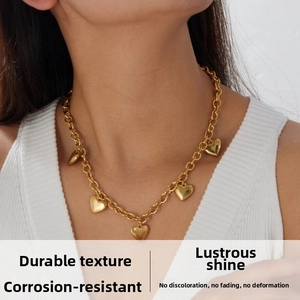 Close-up of gold plated stainless steel chunky chain necklace with heart pendants