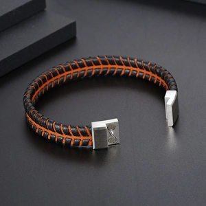 Handwoven black and orange leather bracelet with a silver magnetic metal clasp