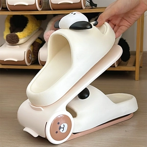 Detail of adjustable plastic shoe rack with cute bear and dog icons in a double-layer design