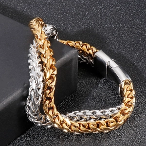 Macro shot of men's double-layer wheat chain bracelet in gold and silver finish