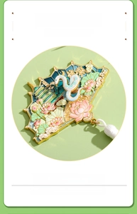 Detail of fan-shaped fridge magnet with relief coloring and white silk tassel