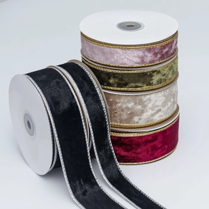 Macro detail of velvet ribbon rolls with metallic gold wire edges for gift wrapping