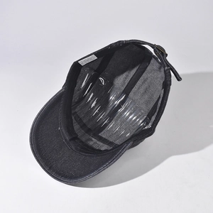 Internal view of black cotton denim cap showing the 100% cotton label and metal buckle