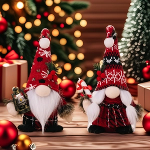 Pair of Christmas faceless gnomes with oil lamp and candy cane on wood surface