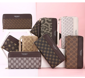 Detail view of various long zip wallets featuring diverse patterns and wrist straps