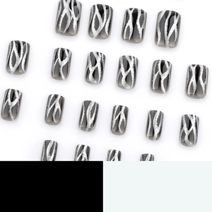 Black gradient press-on nails with silver glitter flame patterns and glossy finish