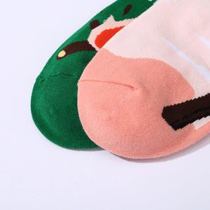Close-up of green and pink knit crew socks showing precise toe stitching and texture