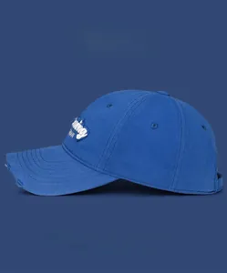 Detail of blue golf baseball cap with frayed brim and white Running 3D embroidery