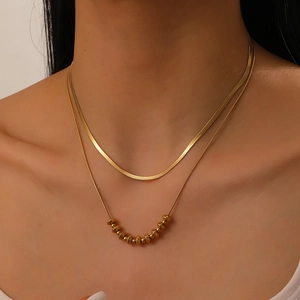 Double-layered gold-plated stainless steel necklace with snake chain and beaded strand