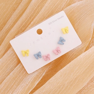 Detailed close-up of colorful bow stud earrings with hypoallergenic S925 silver needles