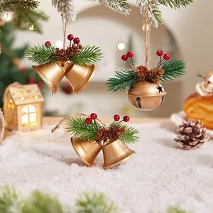 Christmas gold bells set with pine needles, cones and berries on rustic hemp rope