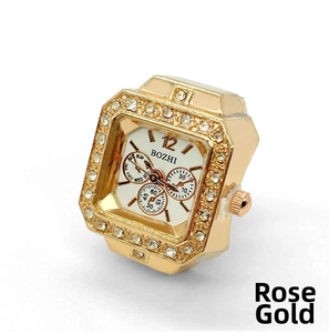 Detail view of square rose gold ring watch featuring crystal bezel and white dial