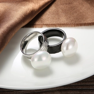 Baroque stainless steel ring set with large white pearls on elegant silk fabric