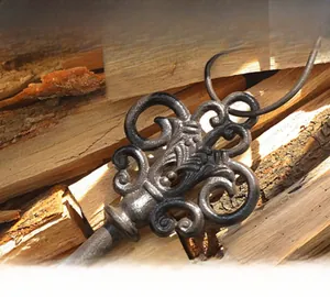 Macro shot of vintage ornate cast iron key with antique bronze finish and intricate patterns