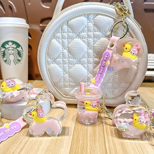 Pink liquid quicksand keychain with cute cartoon figures in milk tea cup and bottle shapes