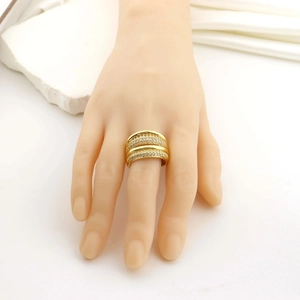 Detailed macro view of a double-row gold ring with crystal inlay on a display hand