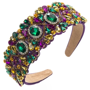Detailed macro view of baroque headband with colorful rhinestones on purple velvet