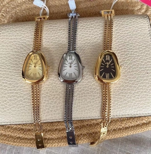 Detailed view of luxury snake head quartz watches with stylish tassel chain straps