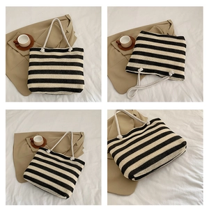 Detail view of woven striped tote bag with rope handles and large capacity design