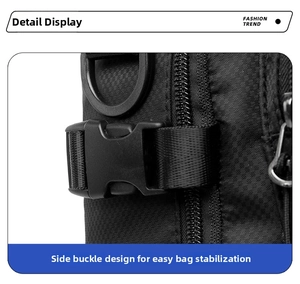Detail of black nylon tactical chest bag featuring a plastic buckle and metal D-ring attachment