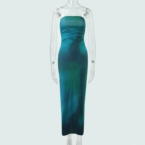 Detailed close-up of blue and green gradient tie-dye fabric with ruching on a slim maxi dress