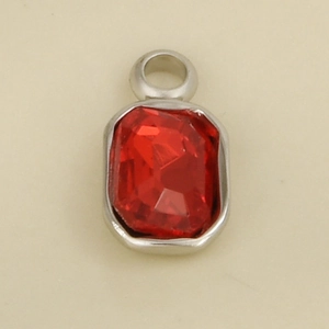 Detail of a rectangular red gemstone pendant with silver stainless steel setting and loop