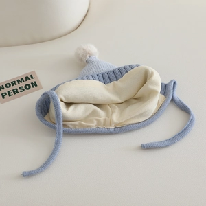 Knit baby winter hat with ear flaps, pompom detail, and warm fleece lining in light blue