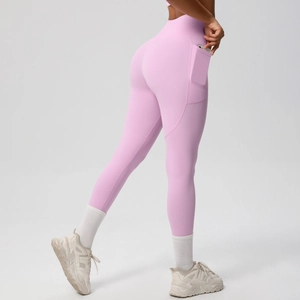 Close-up of high-waist yoga leggings in pink purple featuring a functional side phone pocket