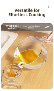 Pouring filtered egg liquid from a transparent mixing bowl with white filter baffle