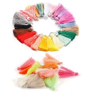 Detailed view of colorful silk tassels with metal rings for jewelry making and DIY crafts