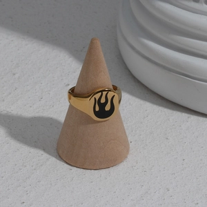 Detail of 18K gold plated stainless steel signet ring with black flame pattern on stand