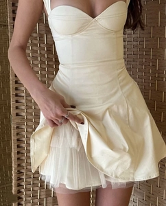 Detail of off-white mini dress showing the mesh petticoat lining and strappy design